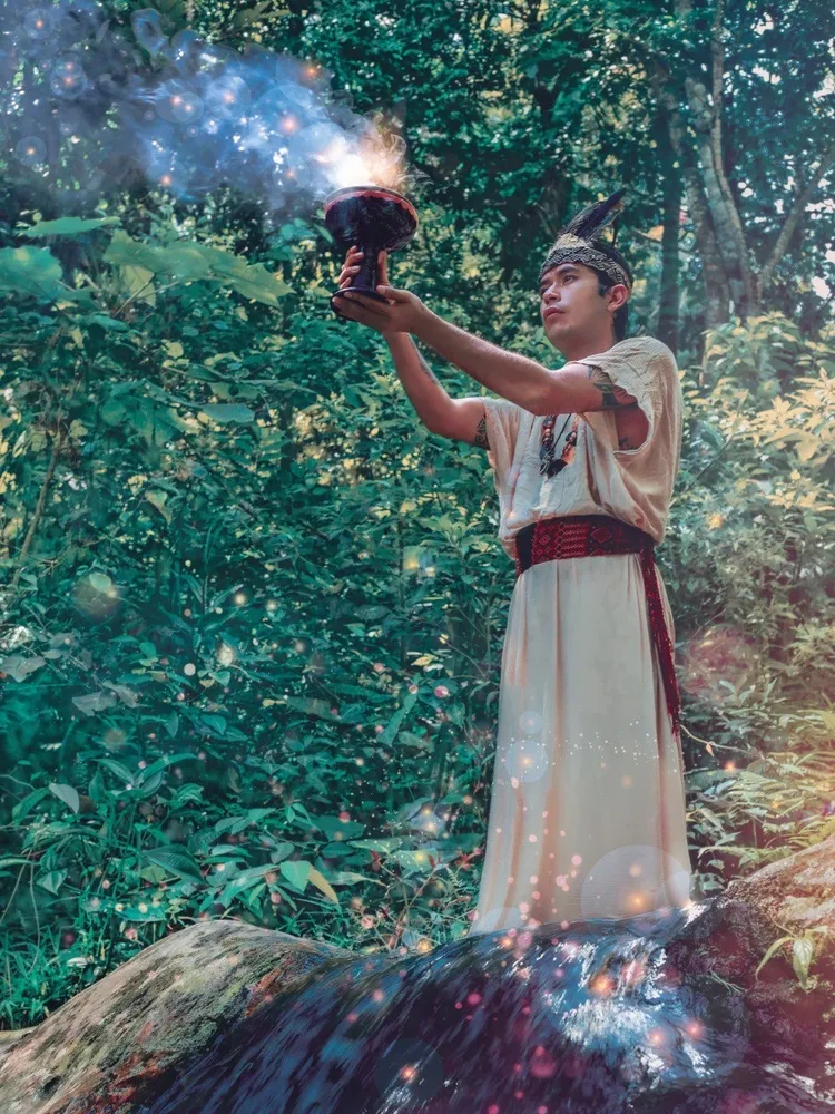 Offering sacred sage in the rainforest light